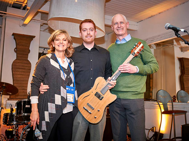 Kathy McKeil, luthier Daniel Clark and Steve Fletcher pose with the custom McKeil 60th Anniversary Guitar, MicMac1956, by Cithara Guitars Inc.