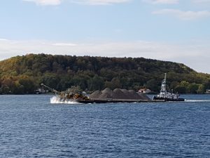 Tug and barge move aggregates in front of Amherst Island